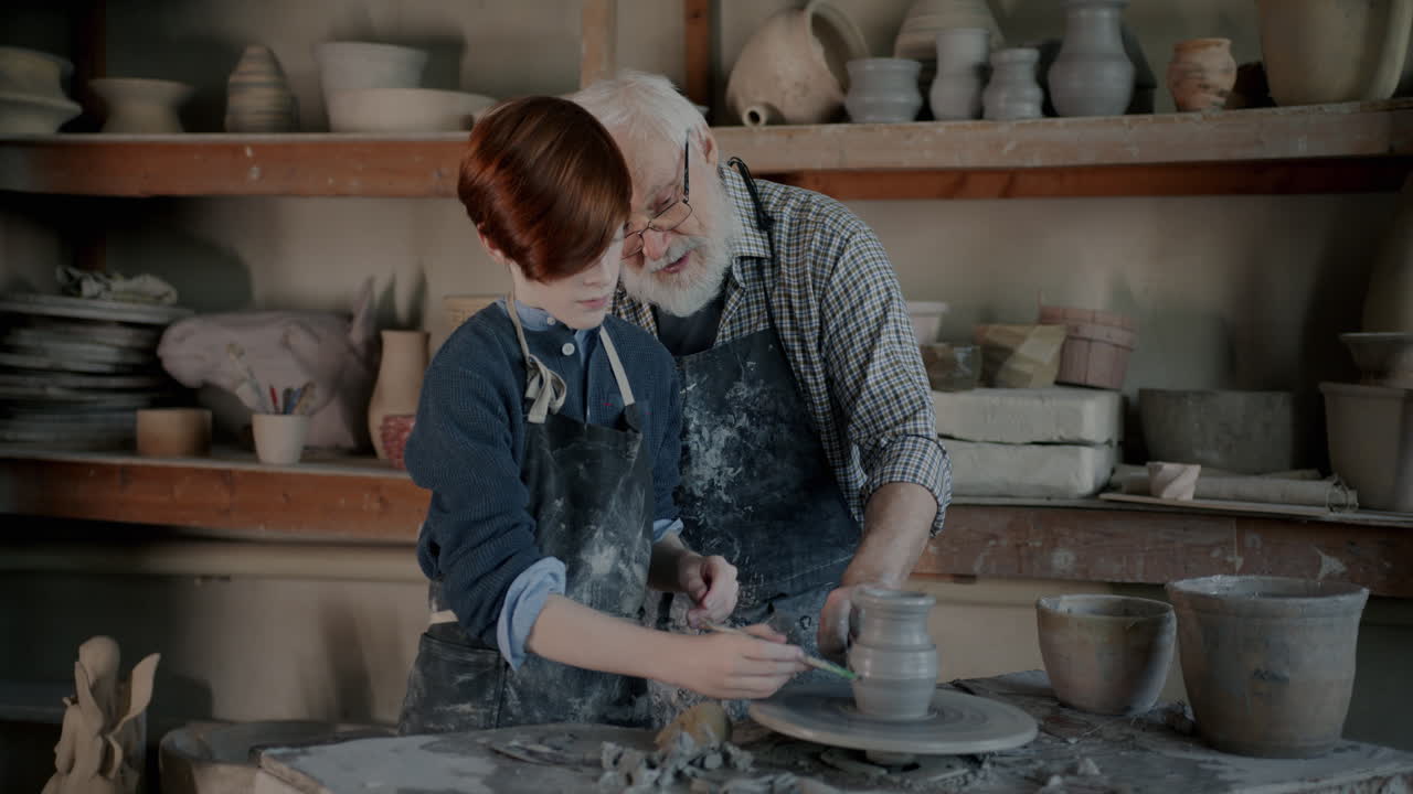 Elderly Potter Teaching a Young Person