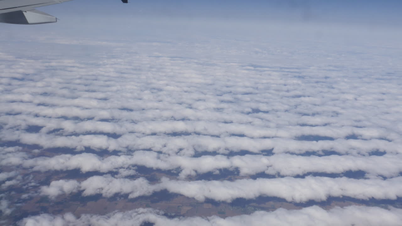 Luftfoto af Amerika over skyerne ud af flyvindue i 4k
