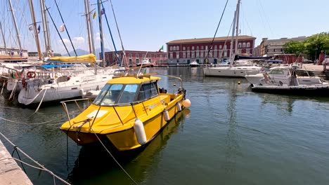 a yellow boat docked in naples, italy