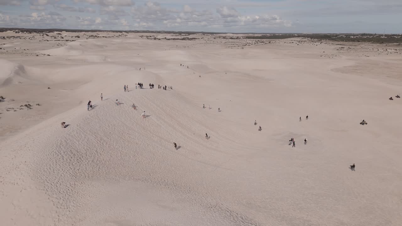 Aerial footage of people sliding down in Lancelin Sand Dunes in Perth, Western Australia