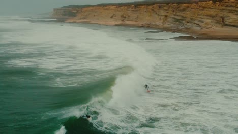 Guys-Riding-Wave-Together-Surfing-Towards-Foz-Do-Lizandro,-Portugal