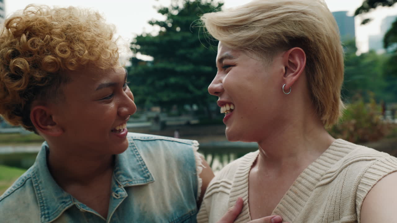 Two friends laughing in an urban park