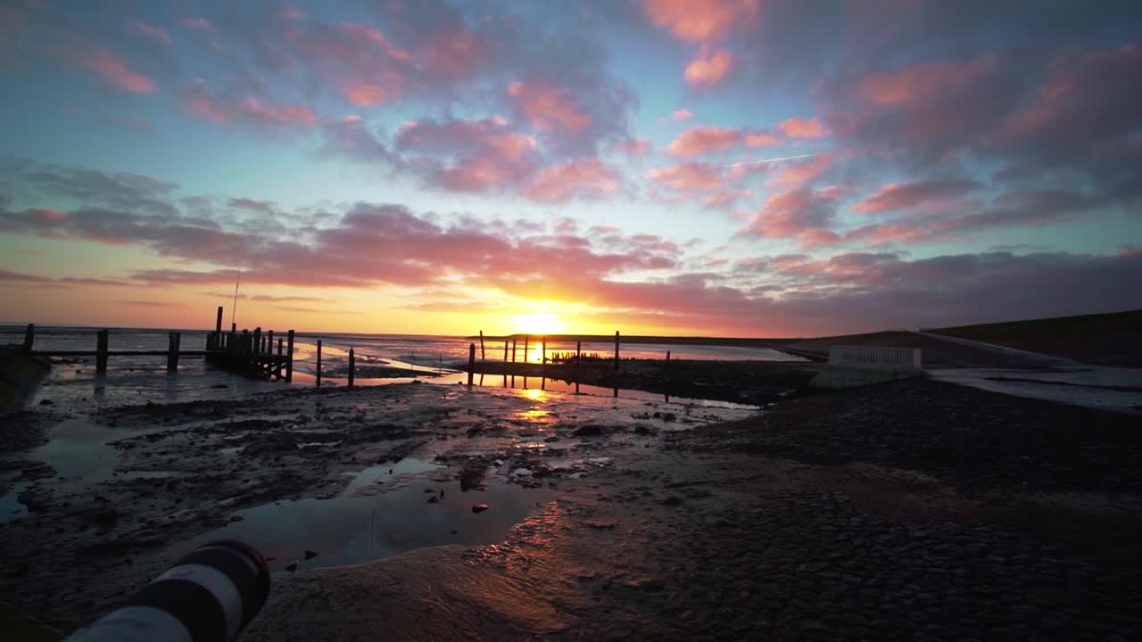 amanecer tranquilo, vista panorámica sobre el delta del río que conduce al mar y a la playa húmeda en texel, países bajos