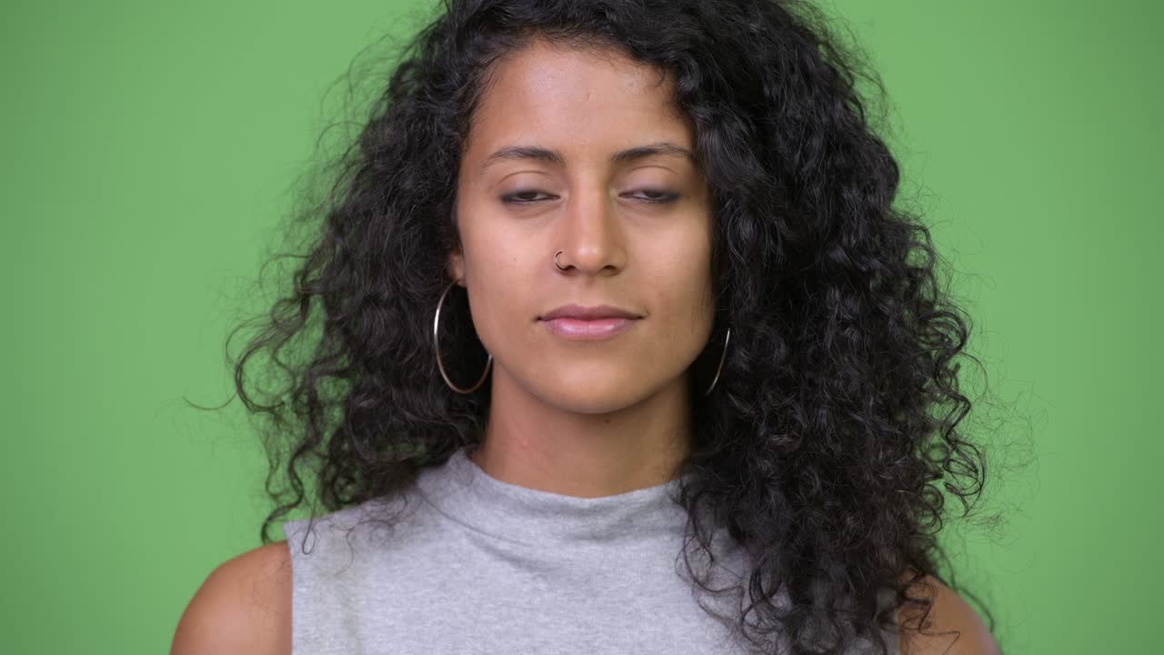 Young happy beautiful Hispanic woman with curly hair