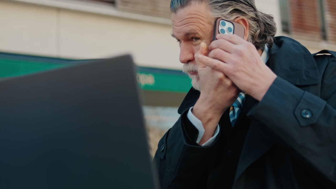 Businessman Working Outdoors on Laptop and Phone