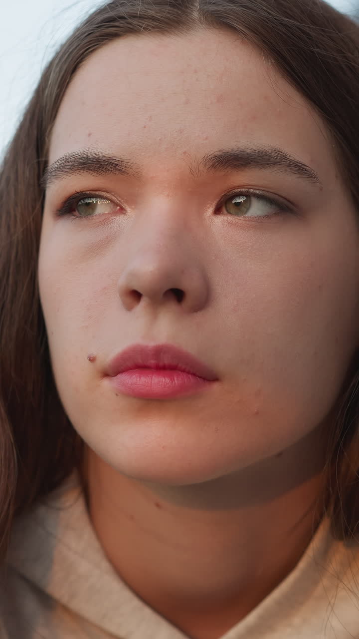 Woman with frustrated look closeup. Depressed woman barely holds back tears reflecting on loss. Young woman wrestles with feelings of depression