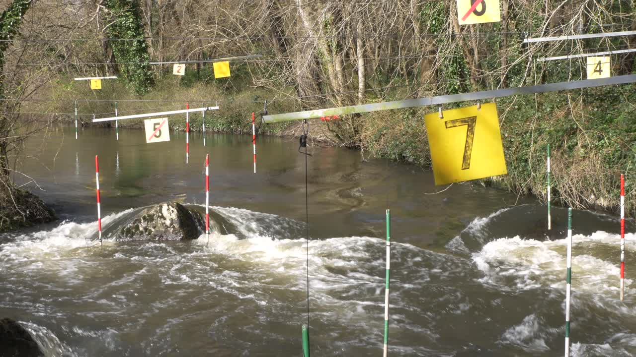 Canoe Slalom Course With Downstream And Upstream Gates Hanged On River Rapids Of Liffey Valley In Dublin, Ireland
