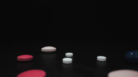 different pills and capsules for virus on black background