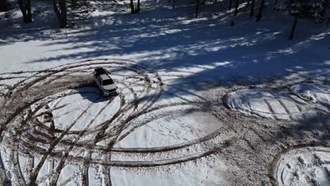 Mountain-vehicle-drifting-in-a-snowy-empty-area,-SUV-car-among-the-snow