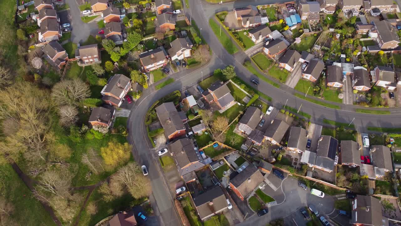 Aerial view of car driving through typical British suburban neighbourhood in Haslington, Cheshire, UK
