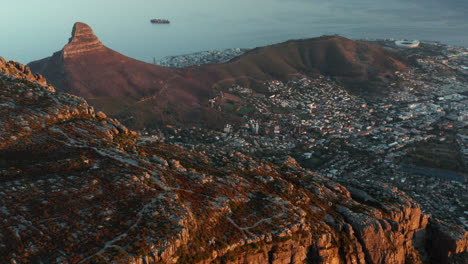 beautiful sunrise over table mountain with in the background lion's head and cape town city in south africa