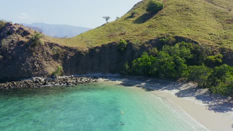 aerial view of pink beach and coral lined waters of komodo national park, flores, indonesia