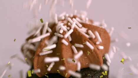 sprinkles falling on chocolate frosted cupcake, celebrating with animation