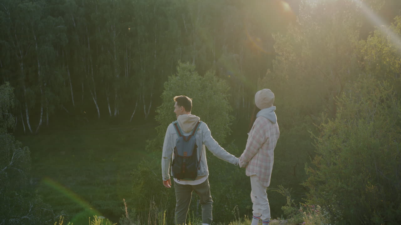 Couple Hiking in Forest at Sunset