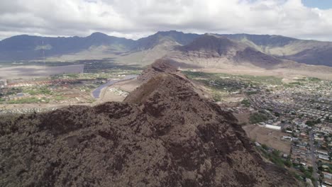 over the edge: a panoramic flight above oahu’s cliffs with a hidden village below