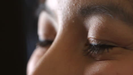 closeup of the eyes of an asian woman talking to