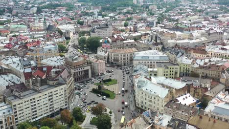 old historical european city with cars driving along the road of lviv ukraine and the skyline in the background