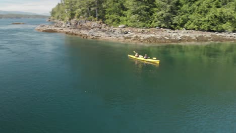 aerial footage of two people in yellow ocean kayak on the ocean