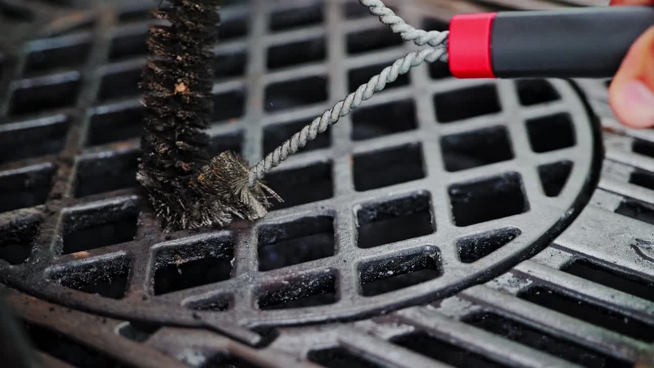 Close up brush cleaning grill grate in slow motion, symbolic fight with disinfo