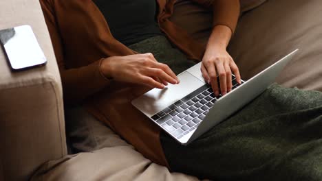 Caucasian-woman-using-a-laptop-at-home