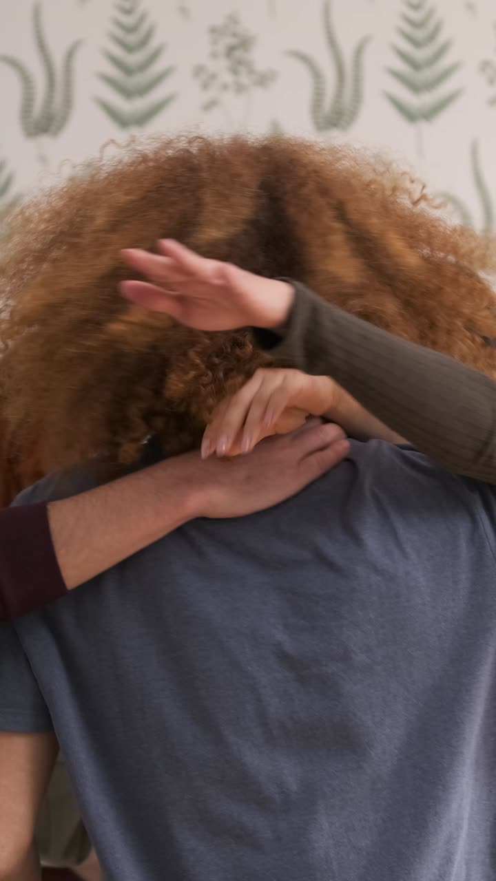 Multiethnic friends hugging each other in apartment