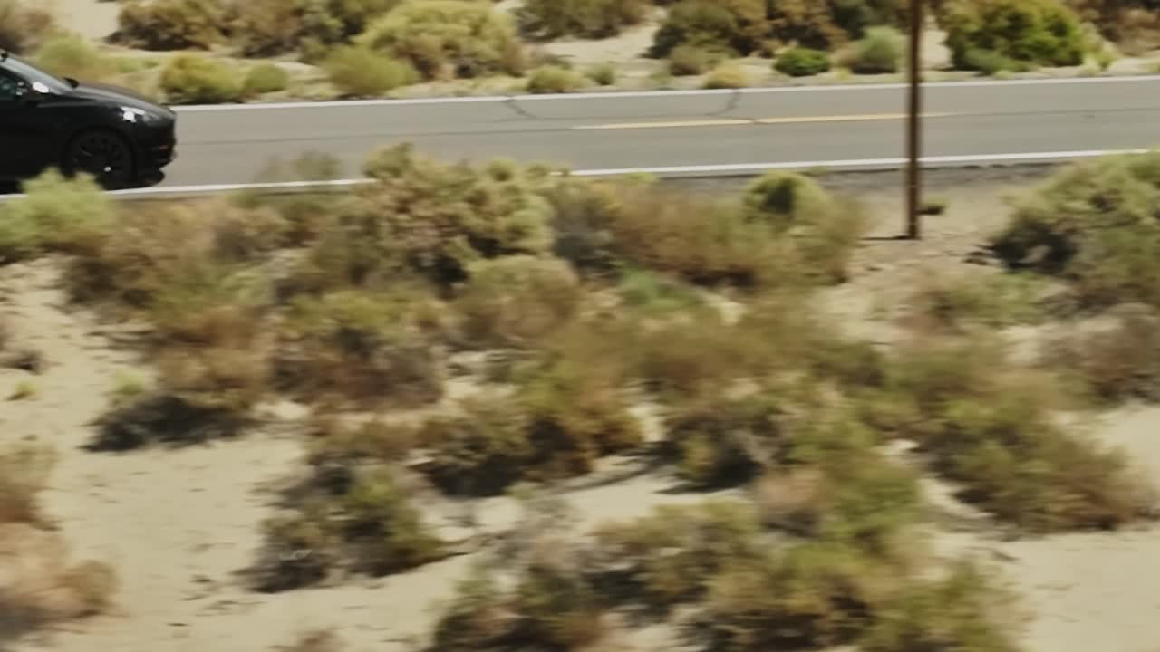 Aerial view of desert landscape and road in USA during daytime