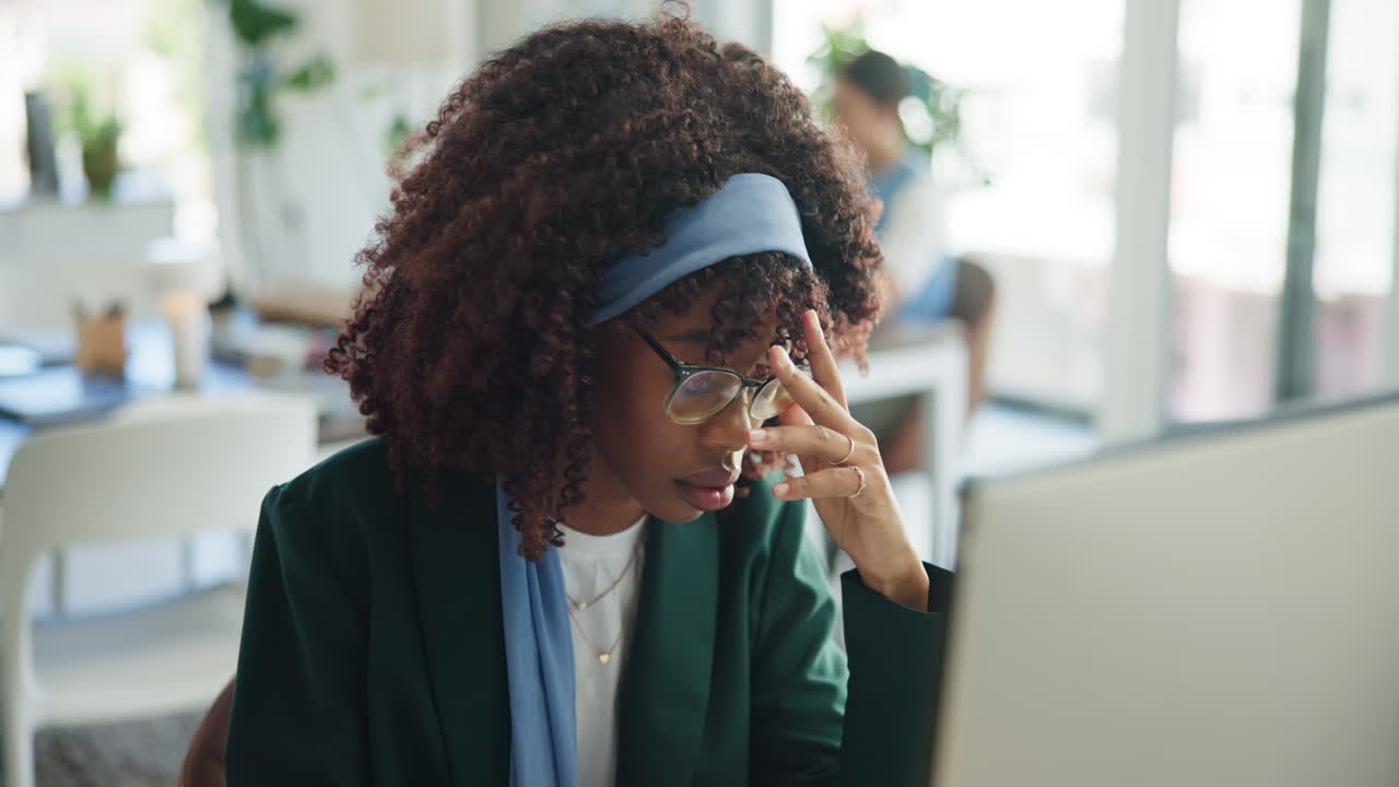 Young African American Woman Experiencing Stress While Working on Computer in Office