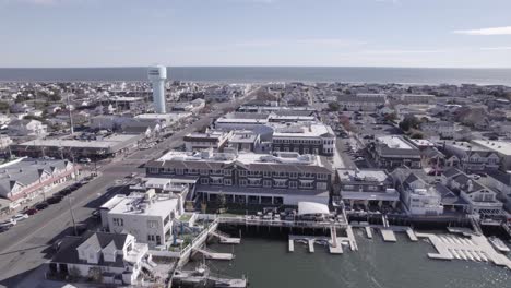 Stone-Harbor,-NJ-Drone-Shot---4K-Flying-Over-Docks-and-Buildings