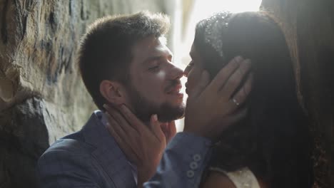 Groom-with-bride-standing-in-cave-of-mountain-hills.-Wedding-couple-in-love