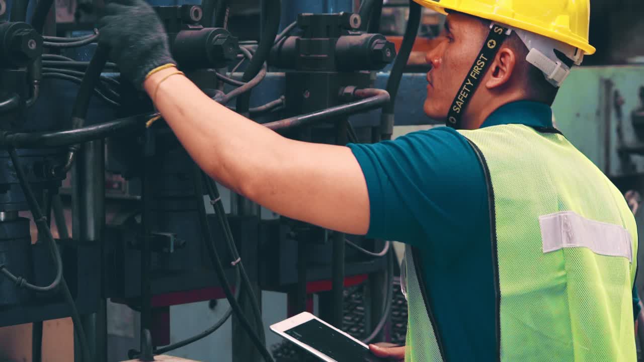 Smart factory worker using machine in factory workshop