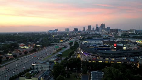 Atlanta,-Georgia-skyline-at-dusk-with-freeway-traffic-and-drone-video-moving-left-to-right