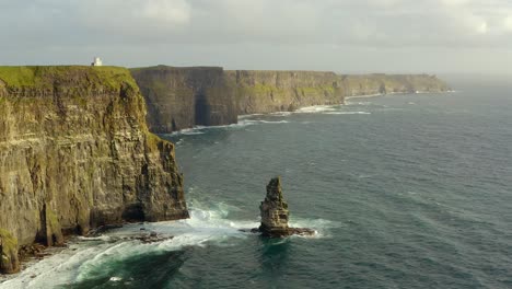 Aerial-pan-at-sea-reveals-the-majestic-length-of-the-Cliffs-of-Mother-at-sunset