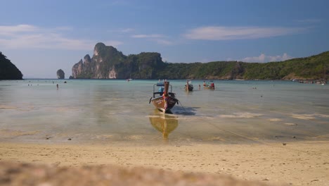 stunning view of a boat arriving at kho phiphi island, thailand with crystal-clear waters