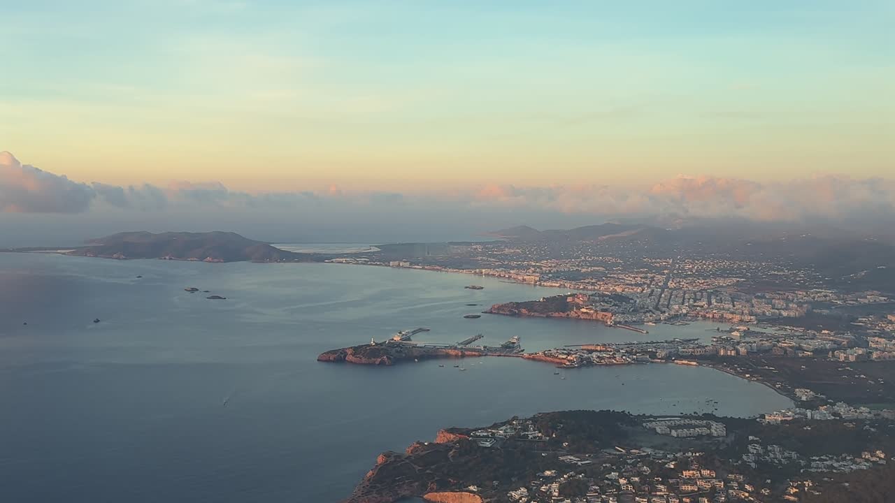 An elevated right side of Ibiza city and surroundings taken at sunrise during the approach to the airport