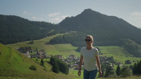 a woman hikes through scenic mountain landscapes in berwang, austria on a sunny day