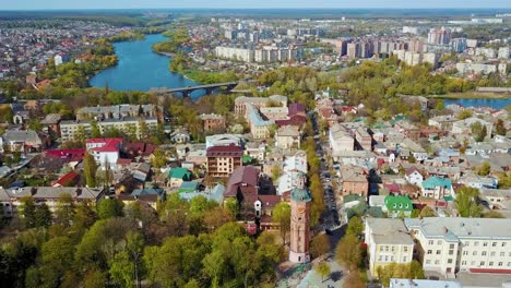 Blue river among urban background. Amazing view of the cityscape with many buildings. Beautiful river in the city. Aerial view.