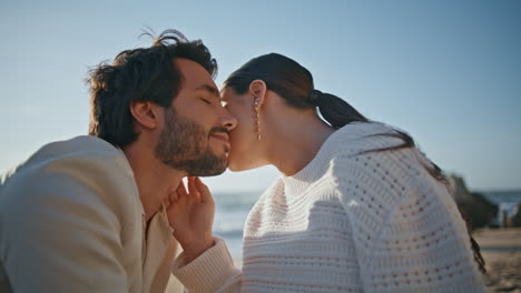 loving woman caressing man face sitting on sunny nature close up. couple in love