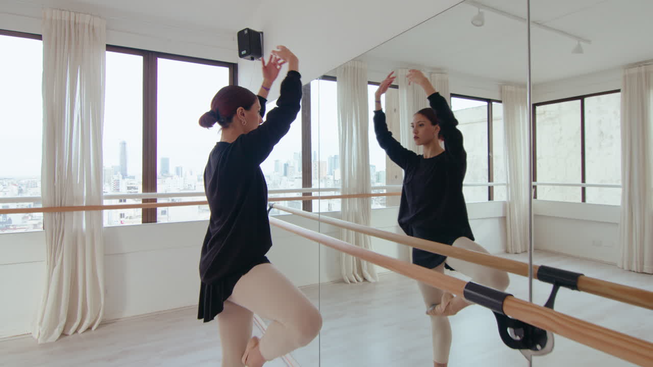 Female Ballet Dancer Practicing Position in Studio