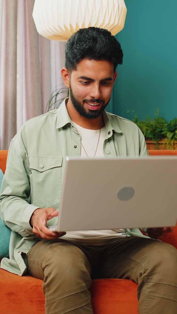 Amazed indian man use laptop computer receive good news message shocked ...