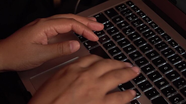 Female hands typing on a laptop