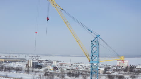 construction crane in a snowy cityscape