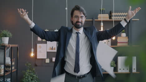 businessman celebrating success by throwing papers