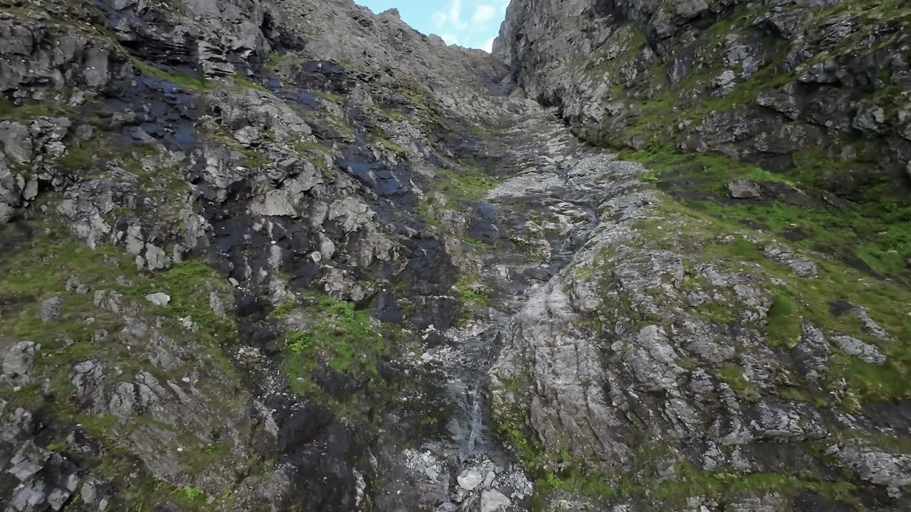An FPV drone's thrilling journey captures the serene beauty of a Norwegian stream in a mesmerizing vertical ascent