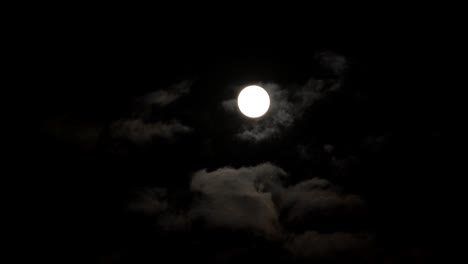 Moon-at-dark-night-sky-with-clouds-passing,-mystery-fairyland-scenery-timelapse