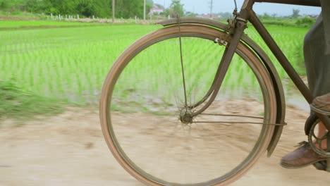 close up of bike wheels and female feet in casual shoes cycling at lang son city, vietnam