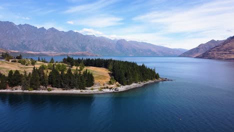 aerial shot of lake wakatipu and golf fields in queenstown, new zealand