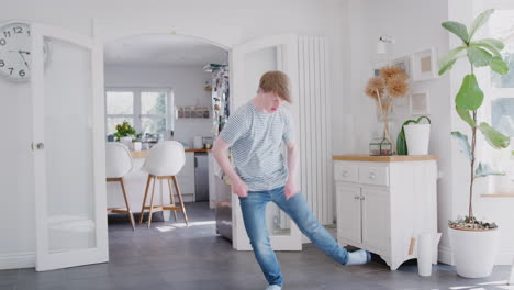 young downs syndrome man having fun dancing at home