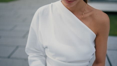 rich businesswoman typing laptop sitting street bench close up. hands texting