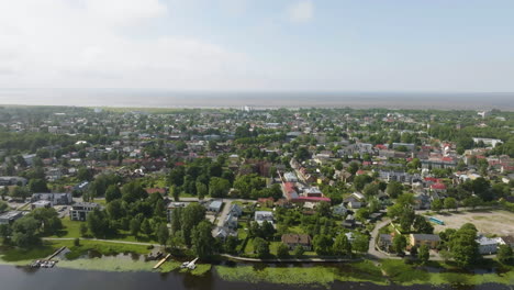 Aerial tracking shot of the cityscape of Parnu, sunny, summer day in Estonia