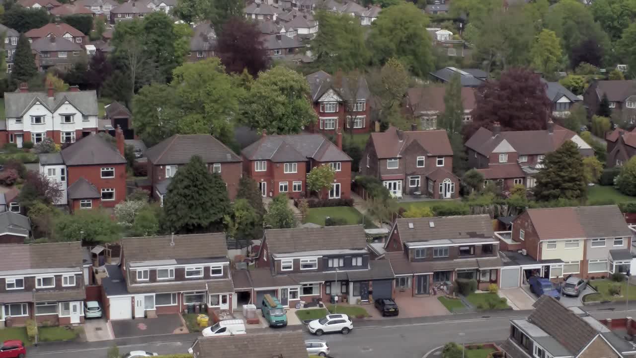 Quiet British roads homes and gardens residential suburban property aerial rising right view tilt down